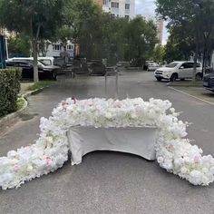 an arrangement of flowers on the street for a wedding ceremony