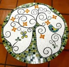 a decorative glass plate sitting on top of a tiled floor