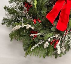 a christmas wreath with red and white decorations