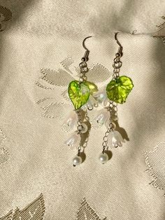 These are dangle earrings inspired by the beautiful Lily of the Valley plant. Perfect for any season, these add a nice touch for any outift. Great to gift for yourself or for another! They are very lightweight and are great for those with smaller ears. There are two finishing options for the earrings, gold plated with a gold plated chain and earring hooks, and silver plated with a silver plated chain and earring hooks.  *CANADIAN SHOPPERS* please note that considering the size of this product it Lily Of The Valley Earrings, Flower Earring, Earring Ideas, Earrings Flower, Earring Hooks, Gold Plated Chains, Lily Of The Valley, Flower Earrings, The Valley