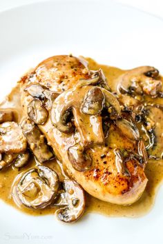 chicken with mushrooms and gravy on a white plate