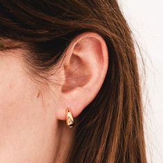 Elevate your ear stack with our Tapered Huggies. These not-too-big, not-too-small earrings boast a sleek and contemporary design, featuring a tapered silhouette that effortlessly hugs your earlobe. Crafted with precision from gold-filled material, these huggies offer a timeless blend of style and comfort, making them the perfect accessory for both the everyday as well as holidays and special occasions. Classic Everyday Pierced Huggie Earrings, Sleek Gold Earrings For Pierced Ears, Classic Teardrop Huggie Earrings For Everyday, Sleek Gold Earrings For Everyday Wear, Classic Gold Wrap Earrings, Sleek Gold Earrings, Everyday Gold Huggie Wrap Earrings, Classic Gold Wrap Earrings For Everyday, Everyday Gold Hypoallergenic Wrap Earrings