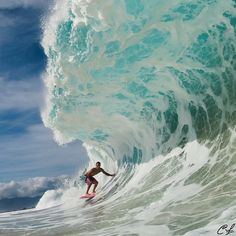 a man riding a wave on top of a surfboard