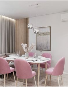 a dining room with pink chairs and a white table