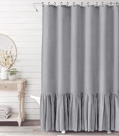 a gray shower curtain with ruffled edges