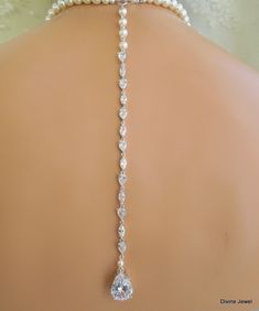 "This glamorous necklace has a radiant cubic zirconia teardrop and Swarovski pearls. Teardrop pendant measures about 3/4\" long by 1/2\" wide. It's strung with 8 mm pearls and 6 mm towards the back. Pearls are accented with rhinestone rondelles. Finished off with a silver lobster claw clasp closure and 2\" extender chain for additional length. This necklace comes with the option of a backdrop. Backdrop is made with hand linked Swarovski pearls and cubic zirconia connectors for a glamorous look. Elegant Teardrop Pendant Lariat Necklace For Wedding, Elegant Cubic Zirconia Lariat Necklace For Wedding, Silver Cubic Zirconia Lariat Necklace For Wedding, Elegant Drop Backdrop Necklace For Wedding, Elegant Wedding Backdrop Necklace With Dangle, Silver Pearl Lariat Necklace For Wedding, Silver Crystal Lariat Necklace For Wedding, Silver Long Drop Backdrop Necklace For Wedding, Wedding Long Drop Lariat Necklace With Pearl