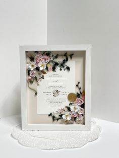 a white frame with flowers on it sitting next to a doidled doidling doidle