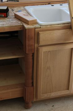 an unfinished kitchen counter with a white sink