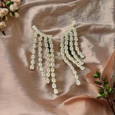 Make a statement with these stunning cascading rhinestone dangle earrings. Perfect for special occasions such as weddings, parties, or festive celebrations, these earrings are designed to dazzle. The intricate design features multiple strands of shimmering rhinestones that catch the light with every movement, adding a touch of glamour to any outfit. Crafted with care, these earrings are lightweight yet durable, ensuring comfort throughout your event. Whether you're looking to elevate your evenin Earrings Statement, Evening Attire, Intricate Design, Multi Strand, Statement Jewelry, Statement Earrings, Statement Pieces, Jewelry Earrings Dangle, Dangle Drop Earrings