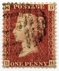 an old postage stamp with the image of a woman's head on red paper