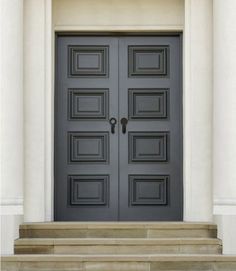 the front door to a building with steps leading up to it