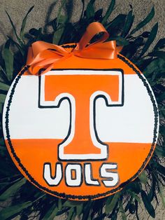 an orange and white door hanger with the letter t on it