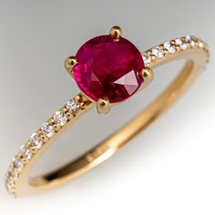 a gold ring with a pink stone and white diamonds