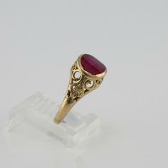 10K Yellow gold Ruby Synthetic Ring, cushion shaped stone, bezel set wear commensurate with age, S and C curls, cutouts to sides, 3/8 inch across, ring size 5.5, Circa 1920, 2.13 grams SKU# BB280R21 This listing contains photographs of the actual item you will receive. Our items are in excellent condition with little or no signs of wear and many are one of a kind pre-owned estate finds. Please look closely at the pictures in this listing as they are part of the product description. Please read t Gold Coin Ring, C Curl, Ring Cushion, Cushion Ring, Coin Ring, Red Band, Fine Jewelry Designers, Boston Ma, Blue Topaz Ring