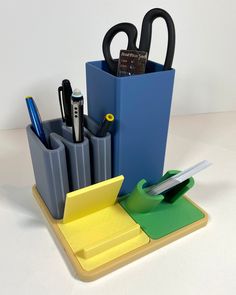 a pen holder with scissors, pens and other office supplies