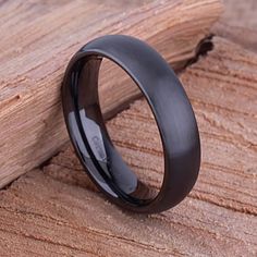 a black ceramic ring sitting on top of a wooden table