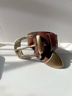 A Handmade Brown Leather Belt for women, that is made from Real Genuine Leather with a unique Gold buckle at the center and two more buckles that i use for decoration. The buckle at the edge of the belt is really special as well. Choose the ideal length for you between 6 different dimensions. (THE DIMENSIONS ARE FOR BELT NOT FOR YOUR WAIST) Find it only at Christina Christi Store. MATERIALS - Real Genuine Leather. - Metal Buckles are made from Zamak. DIMENSIONS - Belt's Width 4 Cm (1.5'') - You Brown Leather Belt Buckle With Metal Pin, Vintage Leather Belt Buckles As Gift, Vintage Belt Buckles With Belt For Gift, Vintage Brown Belt For Gift, Vintage Brown Belt As Gift, Vintage Brown Belt As A Gift, Adjustable Leather Belt Buckle With Metal Buckle, Vintage Adjustable Belt With Buckle Closure, Vintage Gold Leather Belt Buckles