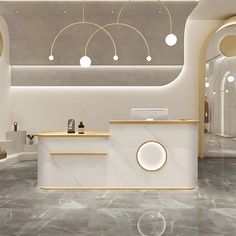 a white reception area with marble flooring and gold trim around the counter, along with round lights hanging from the ceiling