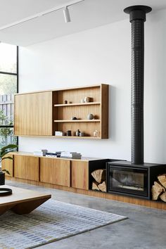 a modern living room with wood furniture and a flat screen tv mounted on the wall