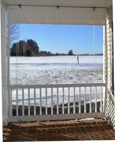 the porch is covered with snow and ice as it sits in front of a lake