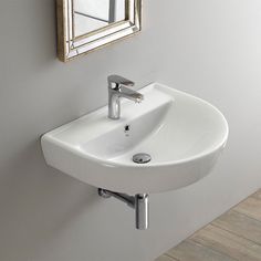 a white bathroom sink sitting under a mirror