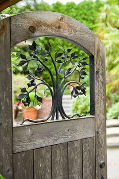 a wooden door with a metal tree on it