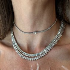 This magnificent tennis necklaces is designed with graduated sizes of Emerald Cut diamonds, a modern take on a classic style. Available in 18K White, Yellow and Rose Gold Diamond weight = 31.36 carats center stone = 1.20ct 2 stones = 0.70ct each 3 stones = 0.40ct each 8 stones = 0.55ct each 15 stones = 0.31ct each 31 stones = 0.25ct each 84 stones = 0.18 each Diamond quality = K/VS1+ Necklace length = 16in Diamond White Cubic Zirconia Tennis Necklace With Baguette Diamonds, Diamond White Baguette Cubic Zirconia Tennis Necklace, Diamond White Tennis Necklace With Baguette Diamonds, White Gold Diamond Tennis Necklace With Baguette Cut, Diamond Baguette Cut Tennis Necklace, Luxury Diamond Baguette Cut Tennis Necklace, Classic Tennis Necklace With Baguette Diamond Cut, Baguette Cut Diamond Tennis Necklace, Classic Baguette Cut Diamond Tennis Necklace