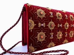 "Burgundy velvet clutch bag, zardozi evening bag, embroidered with copper medallions and embellished with genuine semi precious stones, to give an opulent, multidimensional dazzling effect. This is a gorgeous wardrobe investment piece! A classic design that will never go out of style! A modern heirloom to be cherished! Add instant glamour and elegance to any ensemble! Perfect for any evening occasion, be it wedding, gala, cocktail party. The word Zardozi means \"gold thread\". It is an elaborate Festive Formal Evening Bag With Gold Embroidery, Formal Festive Evening Bag With Gold Embroidery, Designer Evening Bag For Festivals, Designer Festival Evening Bag, Formal Evening Bag With Zari Work For Festivals, Luxury Clutch With Gold Embroidery For Festivals, Gold Clutch With Mirror Work For Formal Occasions, Luxury Gold Embroidery Evening Bag For Festivals, Embroidered Velvet Evening Bag