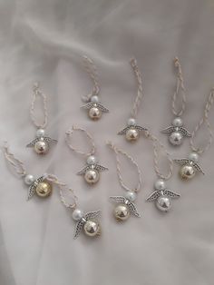 six necklaces with pearls and angel wings