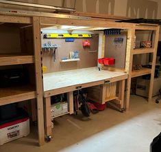 the workbench is made from wood and has many tools on it's shelves