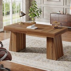 a wooden table sitting in the middle of a living room next to a brown chair