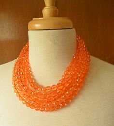 A beaded statement necklace made with translucent faceted orange lucite beads. - Shortest strand measures 18.5-20.5" long- 6 Strands - more are listed - Beads measure 10mm- Stainless Steel lobster claw (sterling silver, gold stainless steel, gold filled also available) - Stainless steel 2" extender chain- Lead free pewter connector The necklace length and number of strands can be customized. The mannequin's neck size is 14.5" for your reference. Larger quantities are available. Please let us kno Orange Statement Necklace, Acrylic Necklace, Silver Jewelry Box, Acrylic Necklaces, Necklace Chunky, Beaded Statement Necklace, Multi Strand Necklace, Strand Necklace, Multi Strand