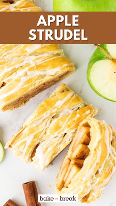 an apple strudel is cut in half and sitting on a white surface with cinnamon sticks