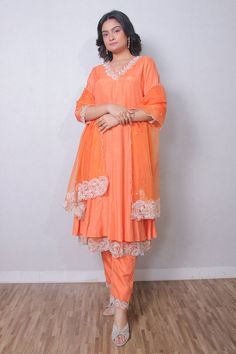 Rust orange silk organza anarkali with resham, sequins and cutdana embroidered neckline, cuffs and double layered hem. Comes with straight pant and a dupatta.
Components: 3
Pattern: Embroidered
Type Of Work: Resham, Sequins, Cutdana
Neckline: V Neck
Sleeve Type: Three quarter
Fabric: Silk organza
Color: Orange
Other Details: 
Embroidered borders on dupatta
Attached lining
Occasion: Mehendi and Haldi - Aza Fashions Peach Chanderi Sets With Sheer Dupatta, Traditional Orange Sharara With Sheer Dupatta, Anarkali Style Peach Palazzo Set With Resham Embroidery, Peach Anarkali Set With Sheer Dupatta, Orange Kurta With Sheer Dupatta For Navratri, Designer Peach Anarkali Set With Sheer Dupatta, Orange Sharara With Sheer Dupatta For Eid, Orange Anarkali Set With Sheer Dupatta, Designer Orange Sets With Dupatta