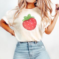 Celebrate love in style with our Watercolor Strawberry Valentine's T-Shirt--a delightful fusion of artistry and comfort. This charming shirt features a heart-shaped watercolor strawberry, a symbol of sweet affection. The intricate design adds a touch of romance, making it a perfect choice for Valentine's Day or any day you want to express love. Available in sizes Small to 3XL, ensuring a comfortable fit for everyone. Choose from an array of elegant colors, including White, Black, Blossom, Pepper, and Ivory, allowing you to personalize your style. Crafted with care and made from premium materials, this T-shirt effortlessly blends fashion and sentiment.  Please see the listing photos for a size chart and choose the appropriate size for your needs.  Refunds and exchanges are not offered for m Relaxed Fit T-shirt With Fruit Print For Spring, Trendy Strawberry Print Cotton Shirt, Strawberry Print Cotton Crew Neck Top, Cotton Crew Neck Top With Strawberry Print, Trendy Cotton Shirt With Strawberry Print, Cotton Shirt With Strawberry Print For Spring, Strawberry Print Cotton Graphic Tee, Cotton Strawberry Print Graphic Tee, Spring Fruit Print T-shirt With Relaxed Fit