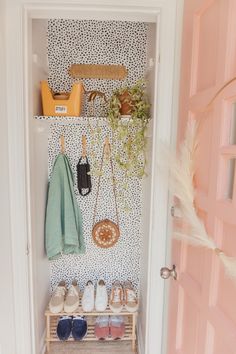 a closet with shoes and bags hanging on the wall