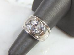 FOR SALE IS A WOMEN'S VINTAGE ESTATE .925 STERLING SILVER CZ RING. THE RING SIZE IS A 7, AND WEIGHS 8.5g. THIS WOULD MAKE A NICE GIFT FOR THAT SOMEONE SPECIAL. ANY OTHER QUESTIONS PLEASE DO NOT HESITATE TO ASK. BE SURE TO CHECK OUT SOME OF MY OTHER GREAT ITEMS UP FOR SALE. THANK YOU. IF THERE ARE ANY ISSUES PLEASE CONTACT US, WE'RE ALWAYS HAPPY TO TRY TO HELP YOU OUT AS BEST AS WE CAN. Classic Silver Topaz Ring, Classic Silver Topaz Ring With Round Band, Classic Silver Topaz Ring With Bezel Setting, Classic Topaz Ring Stamped 925 For Anniversary, Classic Topaz Ring For Anniversary, Classic Round Topaz Ring, Sterling Silver Cz Rings, Gold Heart Bracelet, Garnet And Diamond Ring