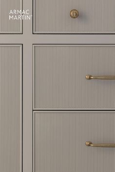 the drawers are painted gray and have brass handles on each drawer, which is labeled armmag martin