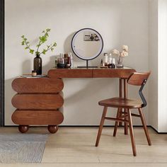 a wooden desk and chair in front of a white wall with a mirror on it