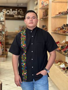 This beautiful Traditional Guayabera for Men is embroidered and adds a sophisticated flare to your wardrobe.  This elegant button up Shirt is perfect for special occasions such as Mexican Fiestas, Quinceañeras, Weddings, etc. This guayabera is handmade and completely hand embroidered by Mexican Artisans in Oaxaca, Mexico. More styles available here: https://www.etsy.com/es/shop/SoleiEthnic?ref=seller-platform-mcnav&section_id=26873542 Traditional Fit Short Sleeve Shirt, Casual Embroidered Shirt Traditional Fit, Casual Embroidered Shirt With Traditional Fit, Traditional Black Shirt With Floral Embroidery, Traditional Short Sleeve Shirt With Multicolor Embroidery, Mexican Men, Men Formal, Mens Oxfords, Button Up Shirt