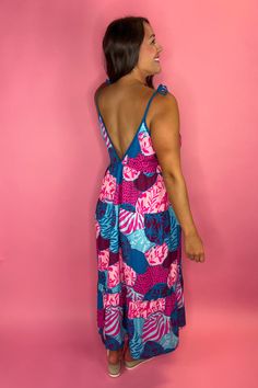 This stunning Maxi Dress is not only head turning but also so comfortable. The soft material is super lightweight so even on the hottest day you'll feel the breeze. Perfect to dress up for a vacation dinner date or dress down with some sandals for the beach Adjustable tie straps FIT: Runs big, size down. Model is a size 8, wearing a medium, but also could have worn the small. 95% Polyester, 5% Spandex Summer V-neck Maxi Dress With Tie Fastening, Beachy Maxi Dress With Tropical Print For Beach Cover-up, Pink Beachwear Dress With Adjustable Straps, Chic Pink Maxi Dress With Tie Straps, Summer Tropical Print Maxi Dress For Day Out, Summer Maxi Dress With Tropical Print For Day Out, Beachwear Halter Neck Dress With Tie Straps, Blue Beach Dress With Knotted Straps, Beachwear Dress With Tie Straps And Halter Neck