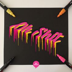 some crayons are laying on top of a piece of paper with the word pop art written in it