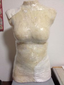 a mannequin is covered with plastic wrap