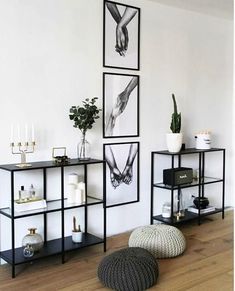 a living room filled with furniture and pictures hanging on the wall above it's shelves