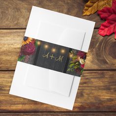 a card with the word mom written on it next to autumn leaves and pumpkins