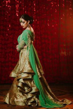 Sadia - Contemporary Asymmetrical Green Bridal Saree Style Lehenga with pearl work Look like a modern bride of today's time and take the dance floor by storm in this unique ensemble saree like lengha! Asymmetric one-shoulder designer blouse with pre draped feature & pearl work Georgette fabric used to give you the benefit of a good drape feature Modern single-shoulder detail with pre draped saree like pleats makes this piece an absolute stunner Interesting crystal beadwork runs all over neckline Festive Gown With Traditional Drape For Reception, Traditional Drape Cutdana Wedding Gown, Bollywood Style Festive Gown With Traditional Drape, Bollywood Style Gown With Traditional Drape For Reception, Raw Silk Gown With Traditional Drape For Reception, Traditional Drape Gown For Wedding Festivals, Traditional Drape Pre-draped Saree For Wedding And Navratri, Traditional Drape Art Silk Wedding Gown, Bollywood Style Gown With Traditional Drape