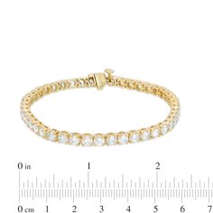 Wrap your wrist in a classic style with this magnificent diamond tennis bracelet in yellow gold. Created in 14K gold Diamonds - the largest being 1/4 ct. each - sparkle in endless line. Wear this style solo or layered with other bracelets. Breathtaking with 9 cts. t.w. of diamonds This 7.25-inch bracelet secures with a box clasp. Classic Gold Tennis Bracelet, Brilliant Cut, Classic Gold Tennis Bracelet With Brilliant Cut, Classic Gold Diamond Bracelet With Prong Setting, Yellow Gold Tennis Bracelet With Brilliant Cut For Anniversary, Classic Yellow Gold Diamond Bracelet With Prong Setting, Anniversary Yellow Gold Tennis Bracelet With Prong Setting, Yellow Gold Tennis Bracelet For Anniversary, Timeless Yellow Gold Tennis Bracelet For Anniversary, Diamond Tennis Bracelet