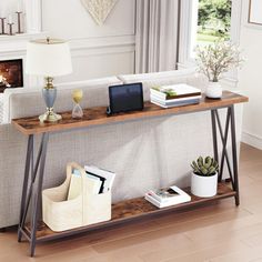 a living room with a couch, coffee table and bookshelf next to a fireplace