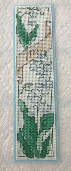 a cross stitch bookmark with flowers on it