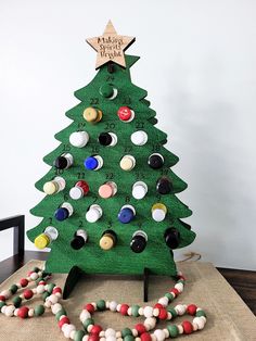 a christmas tree made out of buttons on a table